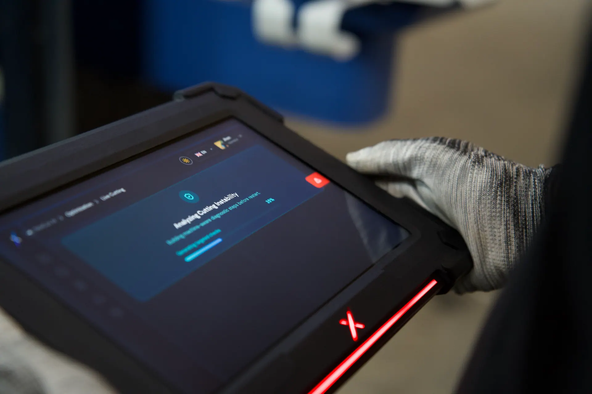 Operator holding the NexCut tablet while it analyses cutting instability