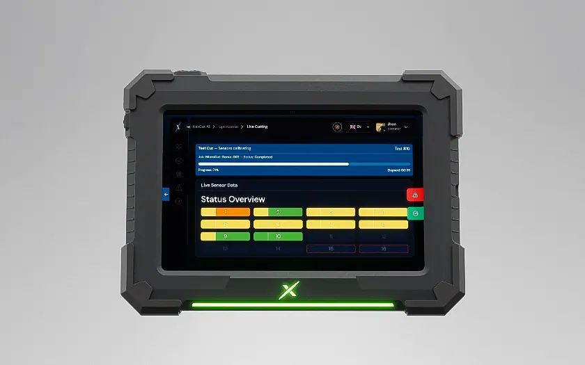 NexCut rugged tablet showing the live status overview, with its green status light on